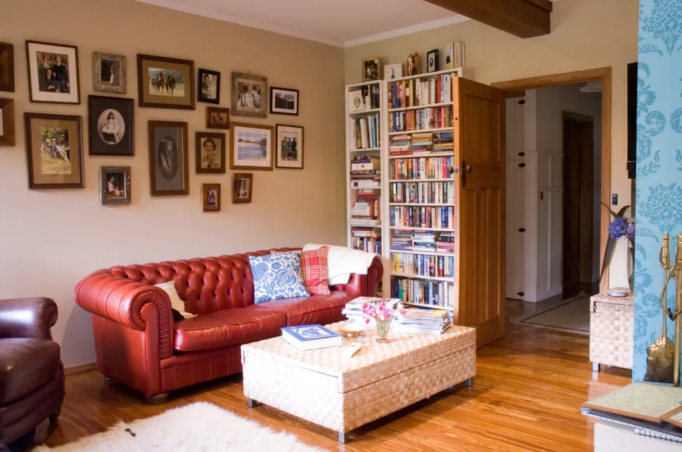 Davis Residence — sitting room with red leather sofa and bookshelves