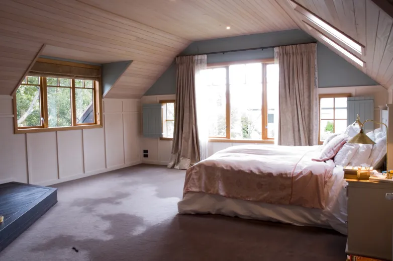 Davis Residence — attic bedroom with sloped timber ceiling