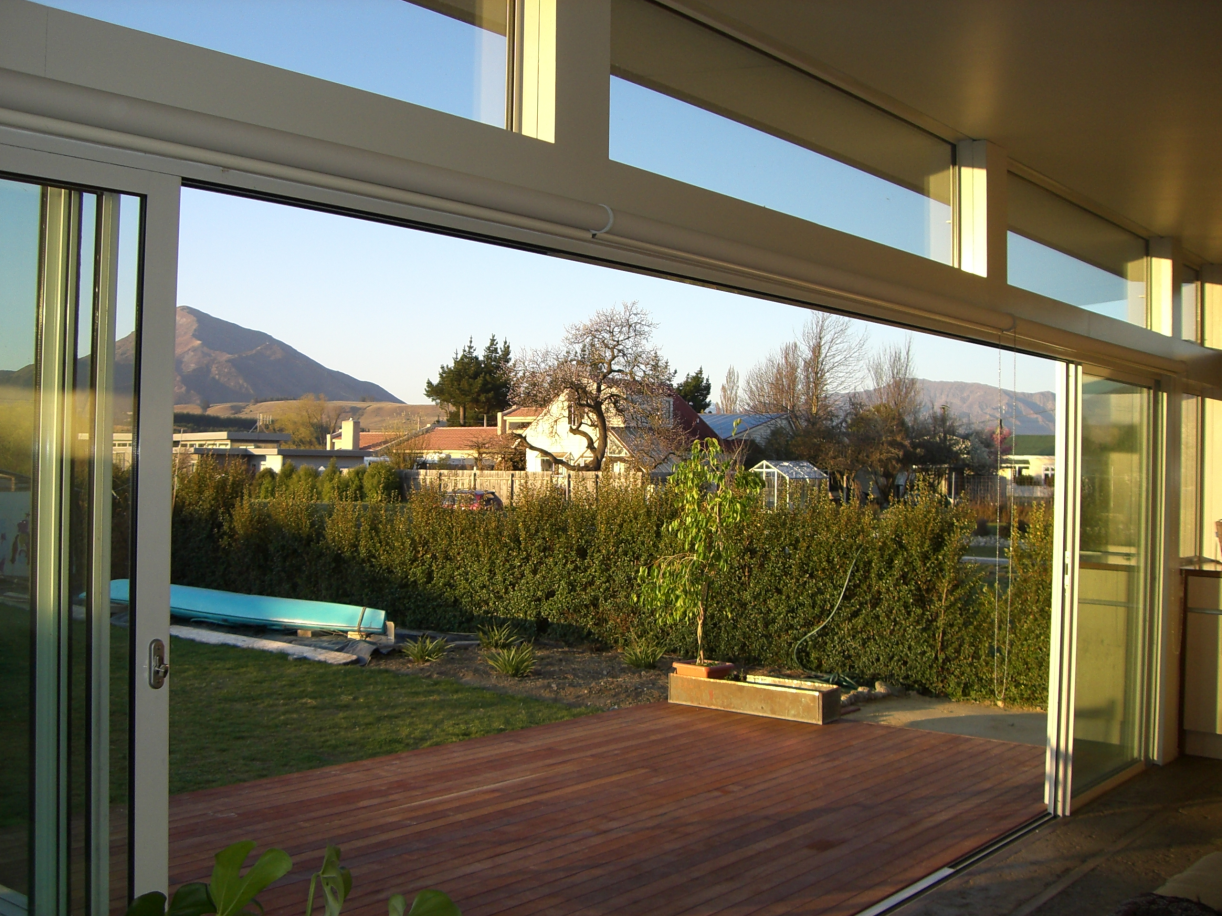 Earth House — view through sliding doors to garden and mountains