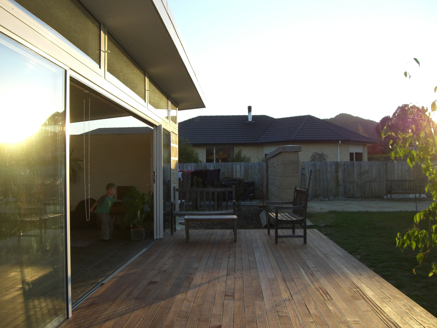 Earth House — deck and exterior at golden hour