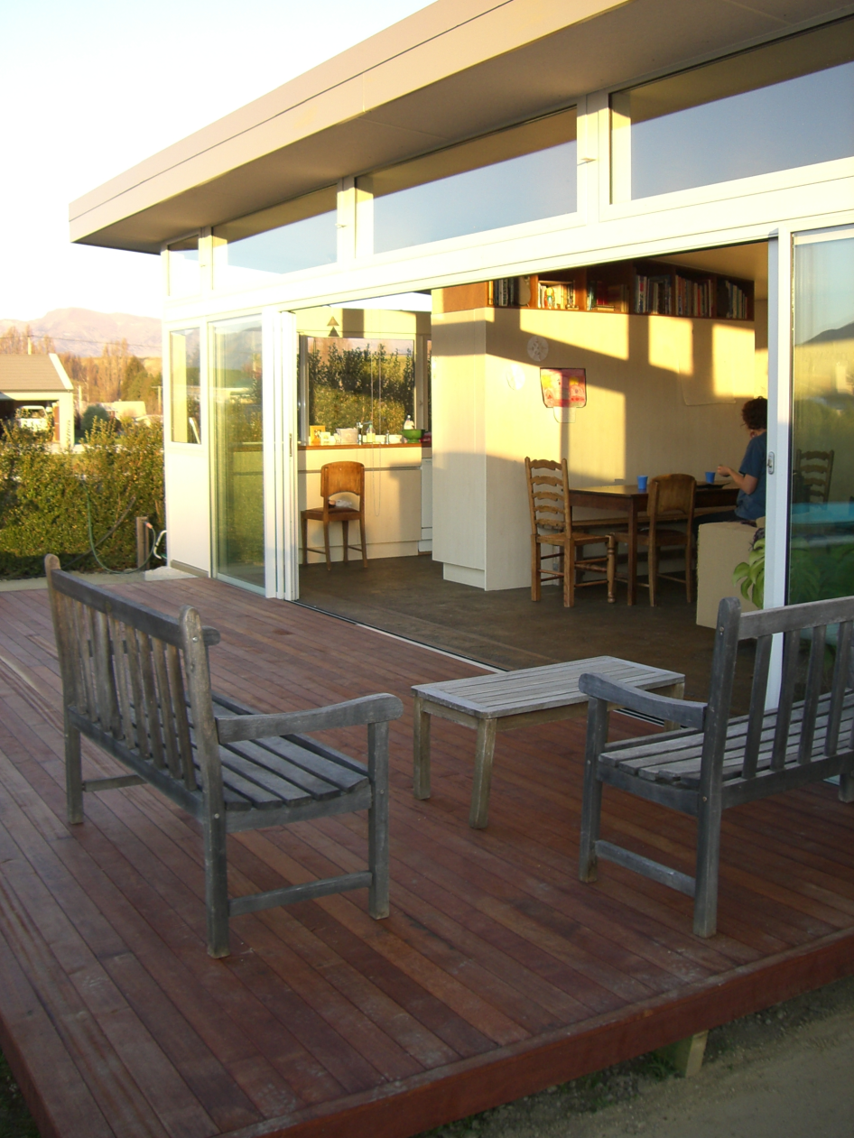 Earth House — deck seating looking back into the living space