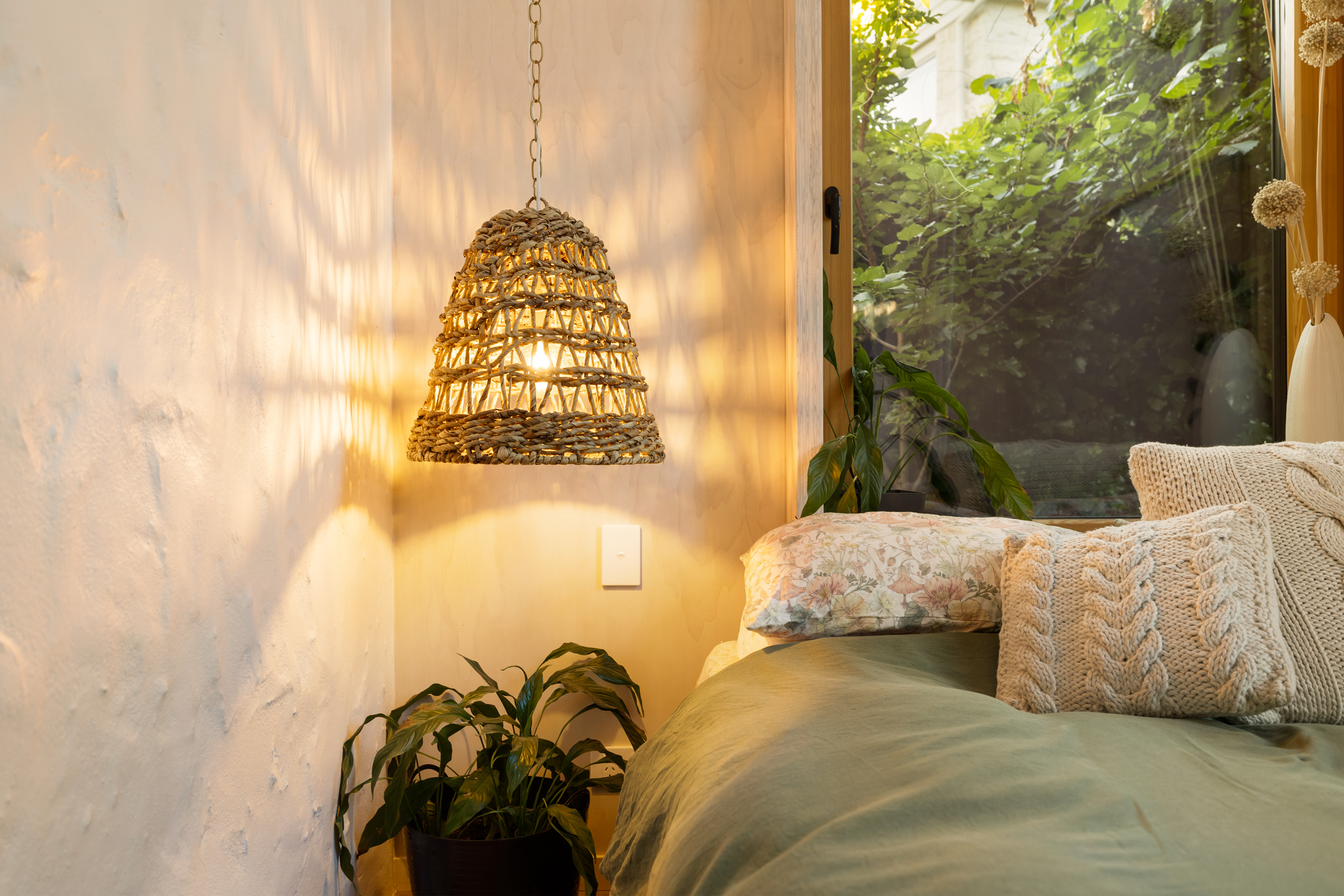Garden House — bedroom with woven pendant light and garden window
