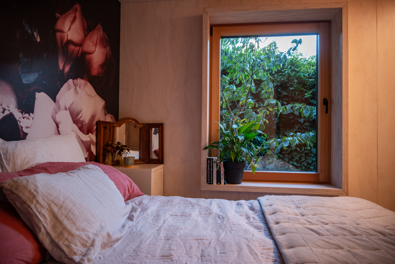 Garden House — bedroom with floral mural wall and window to the garden