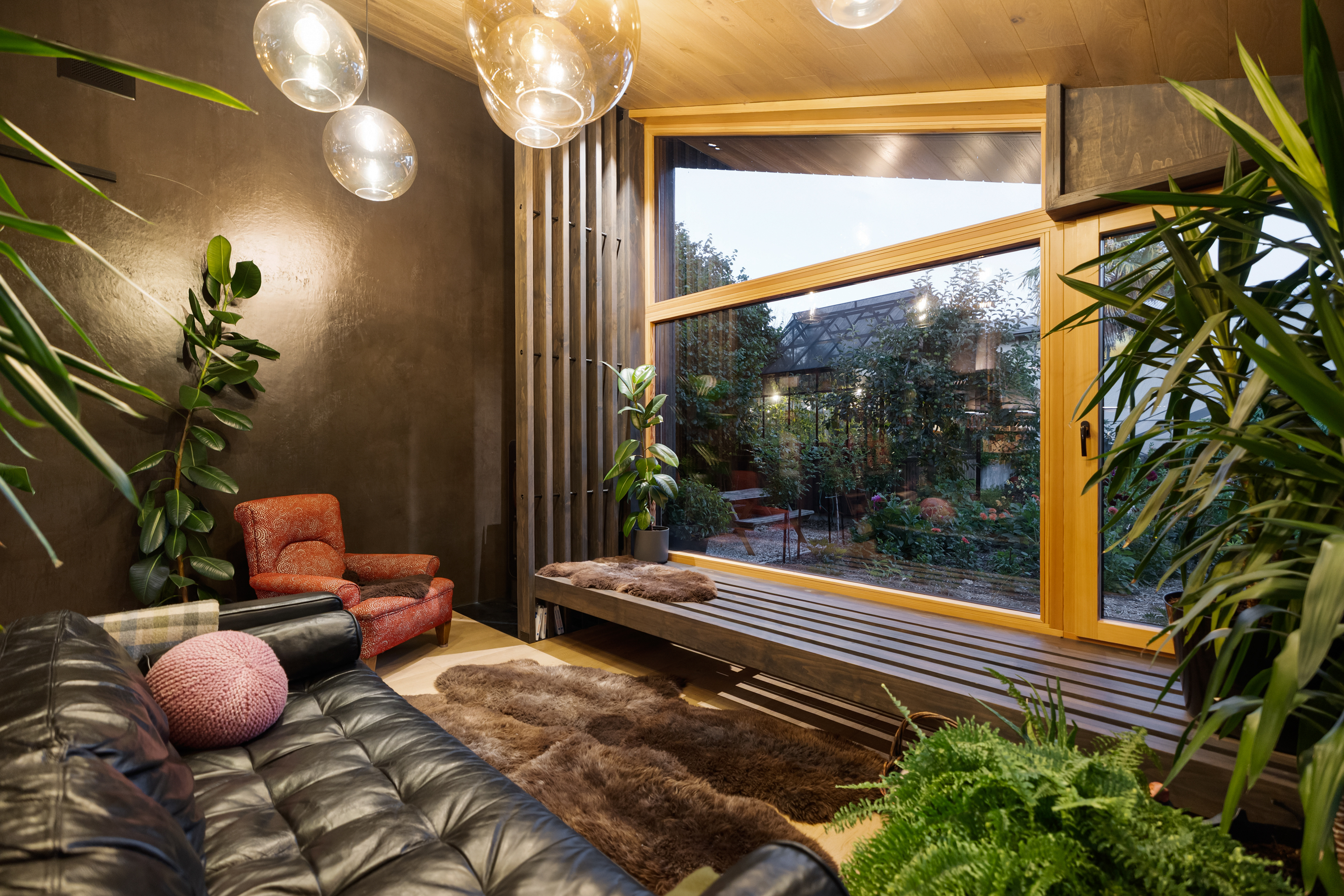 Garden House — living room with leather sofa and window seat over the garden